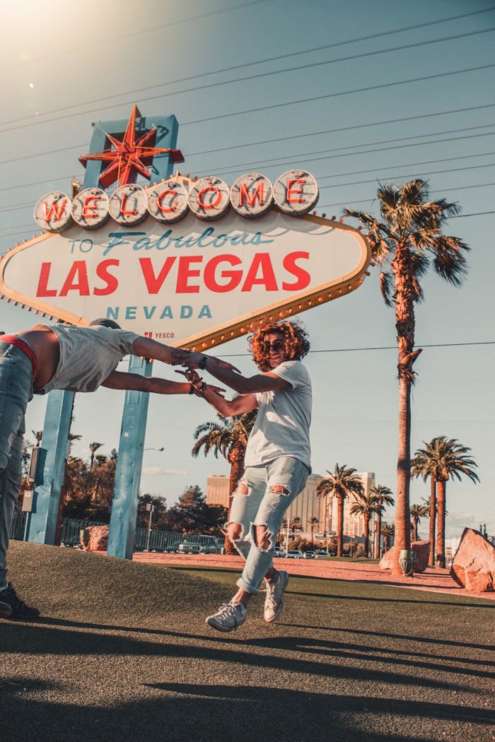 A vibrant scene of friends having fun in front of the iconic Las Vegas sign.